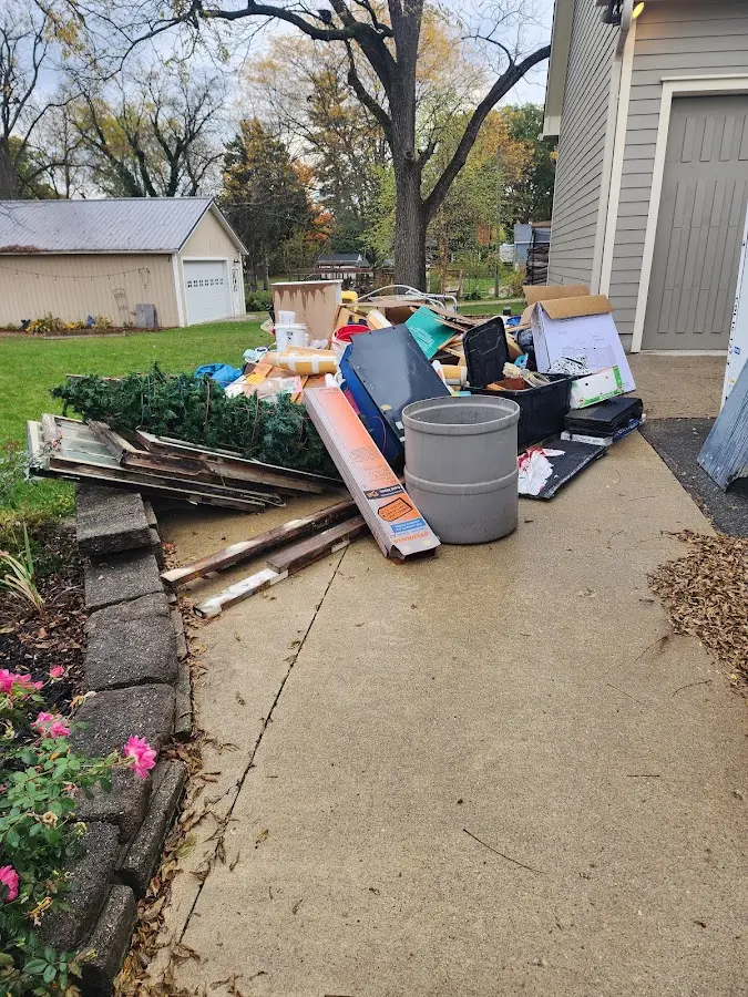 Dumpster being loaded with debris for 10 Yard Dumpster Rental in Macomb
